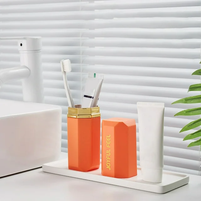 Stylish orange original product toothbrush holder case placed in a modern bathroom setup from our trusted store.