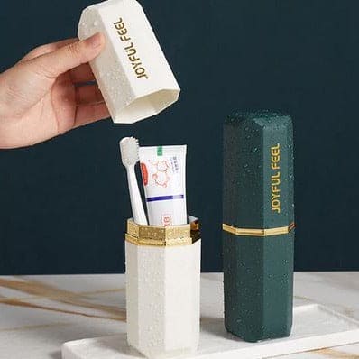 Water droplets on the white and dark green original product toothbrush holder case showing its waterproof and easy-to-clean material.