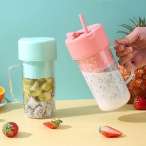 Portable blender bottle in pink and mint green colors being used to mix a fresh dragon fruit smoothie.